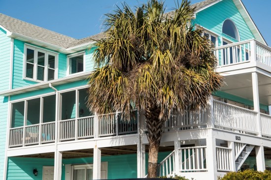 Traditional painted wood railings are still popular in coastal North Carolina communities, but they require regular maintenance.