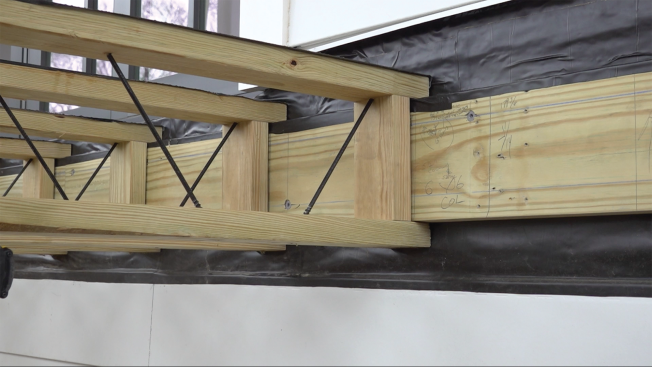 Instead of requiring a joist hanger, the end of an Icon joist goes over and under the ledger and is fastened to it with pairs of structural screws driven down through the top chord and up through the bottom chord and into the ledger. The joists can be ordered with or without waterproofing applied to the top chord. 