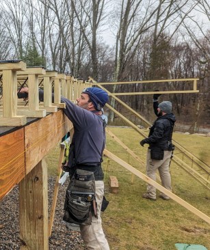 On this project, the Icon joists bear on a two-ply PT LVL dropped perimeter beam supported by PT 6x6 posts, with the top of the beam 1 1/2 inches lower than the bottom of the ledger.