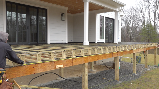 Another intermediate dropped three-ply beam provides midspan support and carries point loads from the columns supporting the porch roof.