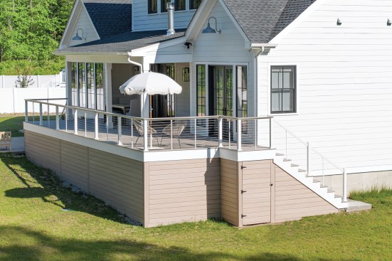 Blocking was also required for the surface-mounted 4x4 rail posts. The small landing for the flight of stairs at the end of the deck was conventionally framed and provides access to storage underneath the deck.
