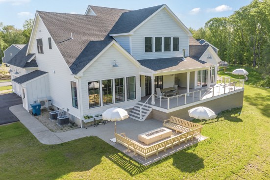 A wider set of stairs at the other end of the deck leads to a poured-concrete patio and sitting area.