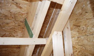 Gable walls are framed with double top plates in lieu of end rafters, breaking conductivity through framing members and creating an unobstructed insulation cavity.