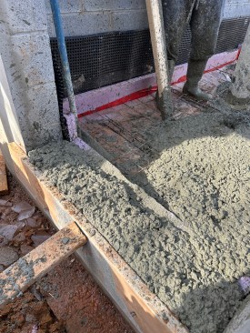 Pouring slab, including filling the last remaining block cores at a french door on the walkout side of the foundation