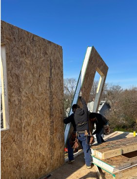 The Queen of Zero framing crew installs one of 90 structural insulated panels (SIPs) that comprise the home’s exterior shell (first and second floors).