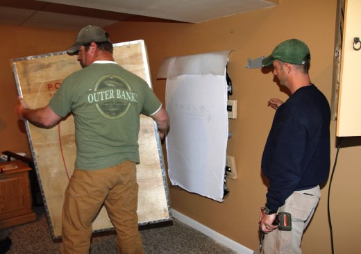 Ritz removes the shipping crate from the unit. 2-by blocking used for packing (shown against the wall) is removed.
