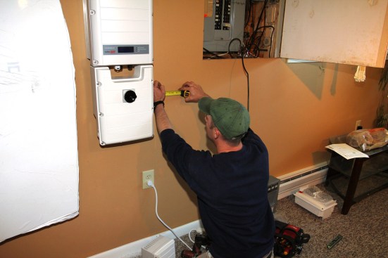 Millette lays out a location for the system's autotransformer unit. The minimum clearance between components is 4 inches, this to allow for ventilation and access to equipment when wiring.