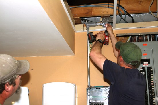 Millette installs EMT conduit from the load center’s subpanel to a junction box in the ceiling for the backed-up circuits. Critical circuits are re-routed from the main distribution panel to this point.