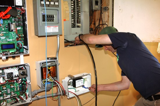 Millette snakes the power feed. Though the home doesn’t have PV solar, he upsizes the feed to #8 cable to accommodate any future solar modules (the power feed will have to carry a 30-amp load, as well as any production current from a PV array).