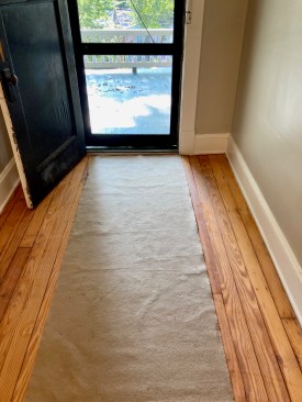 A fabric runner, such Dura Runner, works well for walk-on and walk-off mats at entrances to minimize the tracking in of debris and moisture.