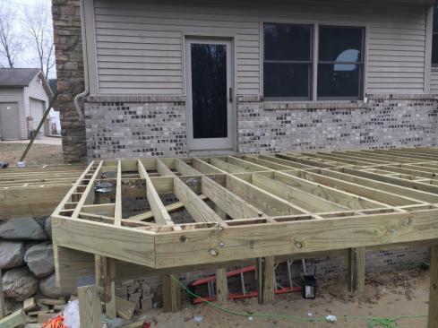Vertically oriented for drainage, blocking has been added to the deck framing in preparation for installing a picture-framed border.
