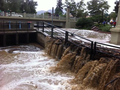 The water rose so quickly that storm responders were overwhelmed. Here spillways remained closed as the water came close to topping the bridge.