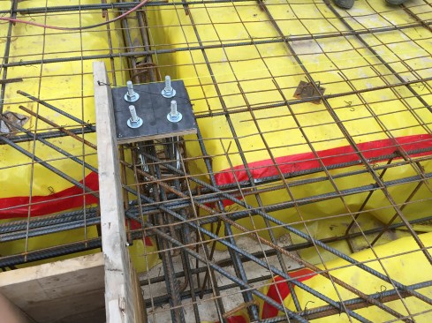 Added reinforcing was required where column bases were integrated into the slab at specific beam intersections.