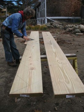 Stringer calculation and layout is the same as for marking cut stringers (see PDB ...... URL)  I draw a heavy line for the tread mark and a light line for the riser mark.  Since the marks aren't cut out and the actual position of the risers will be 3/4 in. behind the stringer nose, the light riser lines can be erased later. I lay out the stringers so the tread mark is the actual top of the finish tread - different than cut stringers where the tread mark is the cut line.  A 1x strip of wood is screwed to the framing square matching the tread and riser heights - I find this is a more precise way to mark stringers than stair gauges or placing the framing square on the stock by eye.