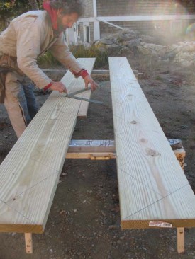 I face the two stringers to mirror one another and use the framing square to mark the mate with the light riser line and the top of tread and bottom of tread lines. Positioning the stringers to mirror one another ensures that I don't mark the same face on both stringers and end up having to remark one.