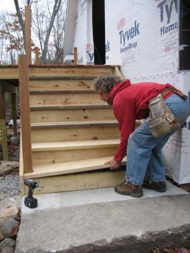 The bottom tread is notched around the 4x4 posts and screwed in place like the other treads. 
