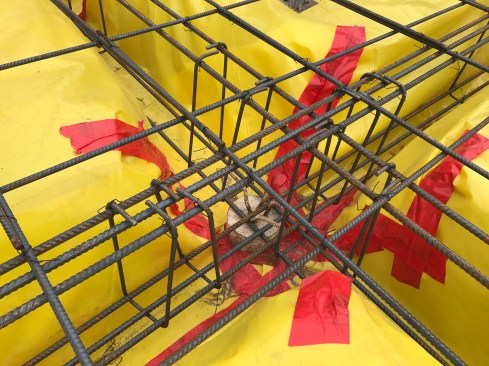 Reinforcing for the grade beams was put in first, formed in sleeves and interlaced with the piles.