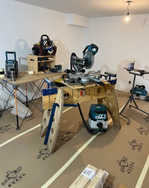 A small jobsite setup for a trim job includes a Tri-Horse saw stand along with a Bora Centipede extendable table. In this setup, the Katz Box serves as a "carpenter's desk," Brian explains.