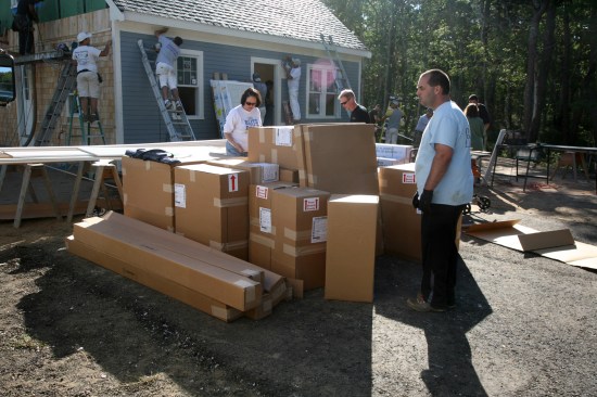 8:55a Kitchen cabinets are dropped off at the site.
