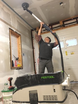Position yourself beneath the sander. Stand as directly under the sander as possible to minimize shoulder strain.  For extended overhead work, Festool sells a harness kit ($260; sold separately).  The harness helps to take off the burden of the weight from the shoulders and transfers more to the hips.  
