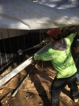 Using a hand-held hydraulic rig, the site crew drove helical screw tie-backs into the earth to a refusal depth of about 12 feet. The tie-backs would restrain a steel-reinforced retaining wall.