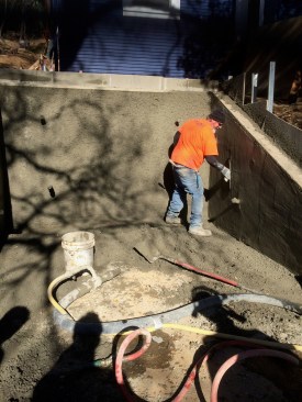 Once the material was applied to the specified thickness, a finisher troweled the material smooth, using the 2x8 top edge of the simple formwork as a guide.