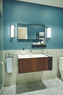 A Moroccan-inspired patterned floor tile, floating vanity, and serene blue paint provided a perfect ensemble for the pool-area bathroom.