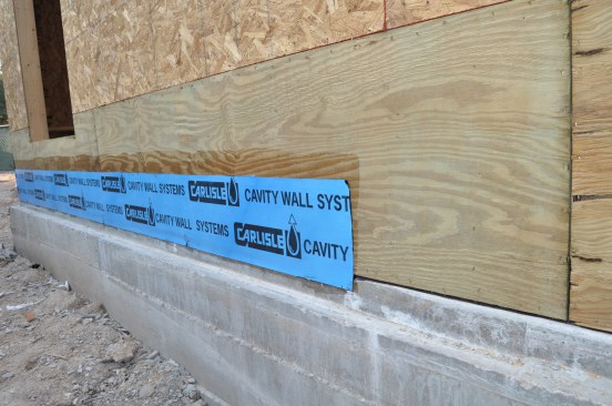 To meet minimum air sealing requirements (3 ACH50 for most of the U.S.) the author air seals between the foundation and the wall framing with peel-and-stick flashing.