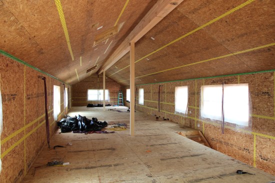 All panel interstections, including the joints between the walls and roof, are taped-off with SIGA tapes (16). Overhangs are framed in after the exterior has been completely air and waler sealed.