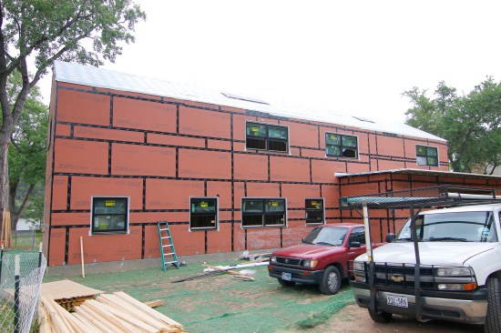 SIPs panels made with ZipWall sheathing get taped off before overhangs installed for a more dependable air and water-seal of the shell.