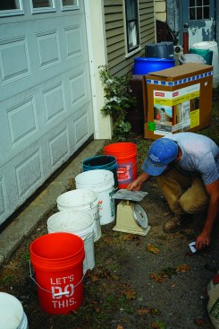 The author weighs out his ingredients using 5-gallon buckets.