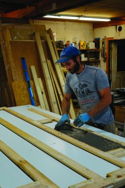 The author packs the stiff concrete into the forms by hand.