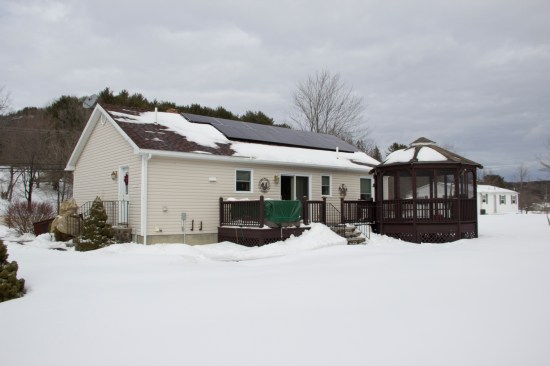 PV panels on this small house are sized to carry much of the home’s annual load, including heat and hot water.