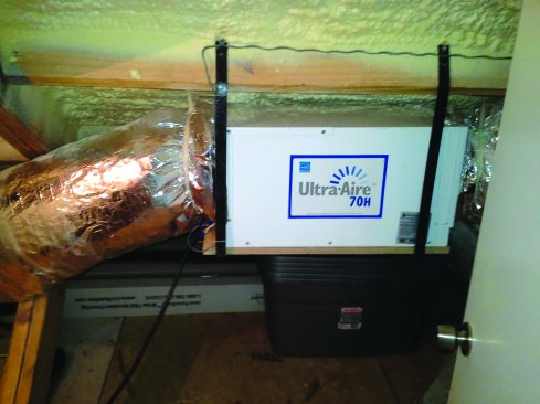 North Carolina builder Tom Dugan installed this Ultra-Aire 70H in his own home. The unit is rated at 70 pints per day and 5 pints per kWh. Dugan tied the dehumidifier into his already installed fan-powered air-mixing duct, which sends air from the home’s highest point down to the ground level.
