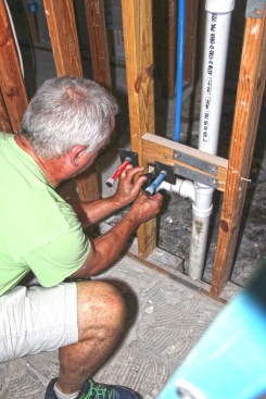 The author tapes over an open drain.