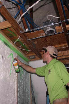 Hovis marks a gap in the foam insulation for correction by the foam crew.