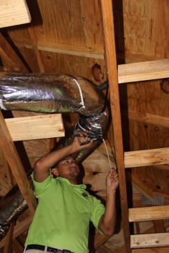 Ventura attaches a Hart and Cooley “Smart Flow Elbow” to ensure good airflow through a curved section of flex duct.