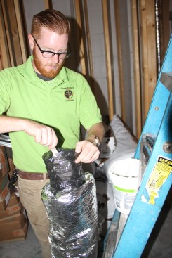 Hogan butters an inner liner with mastic.