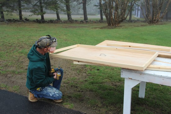 Once the piece is trimmed to fit, he screws a 1x2 edge to the blank.