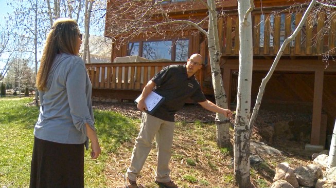 In existing neighborhoods, the fire service is advising homeowners to maintain their properties in a similar way. Arborist Jason Sharp educates a property owner about her choices.