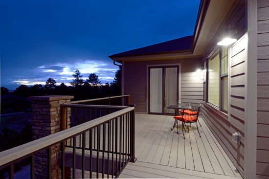 The raised deck is framed with treated wood and decked with composite decking.