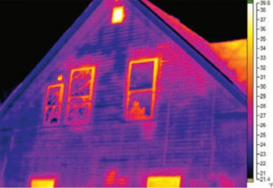 The effect of thermal bridging can be seen immediately in the infrared image. Without continuous exterior insulation, heat conducting through the framing is visible (also visible are air leaks and conductive losses at windows and through spotty patches of insulation).