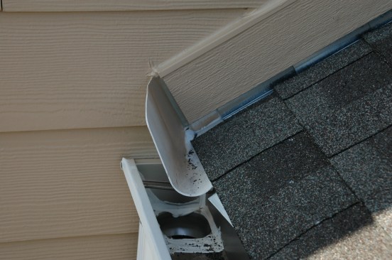 With horizontal siding, the author installs a trim board along the  rake, keeping it a minimum of 1 inch above the roofing.