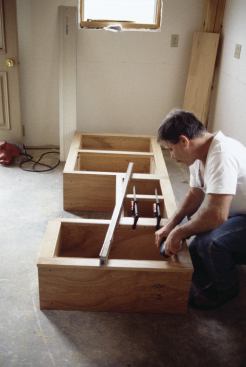 When assembling cabinets in banks, use a level to ensure that face frames are perfectly flush.