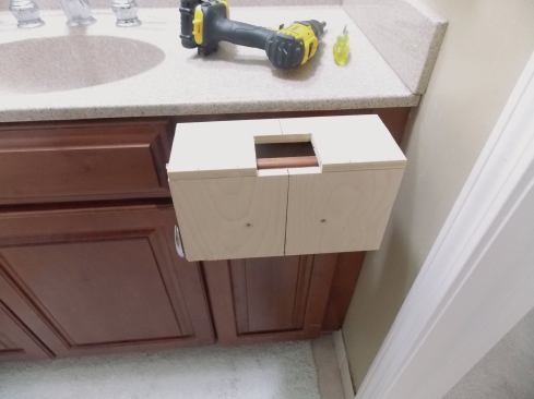 Make and use a simple jig to locate and drill for drawer pulls.