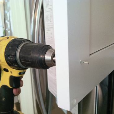After drilling partway through from the back of the door, finish the hole from the front.