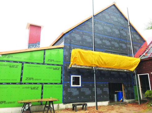Wall membranes taped to the roof membrane and to the addition’s Zip sheathing.