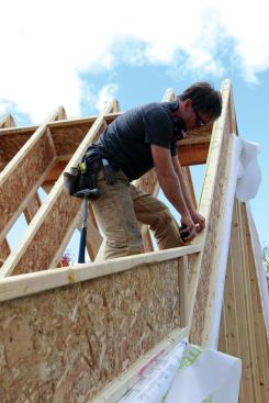 After setting the gable end rafter for the lower section of roof, the author measured down from the main ridge to the point of intersection.