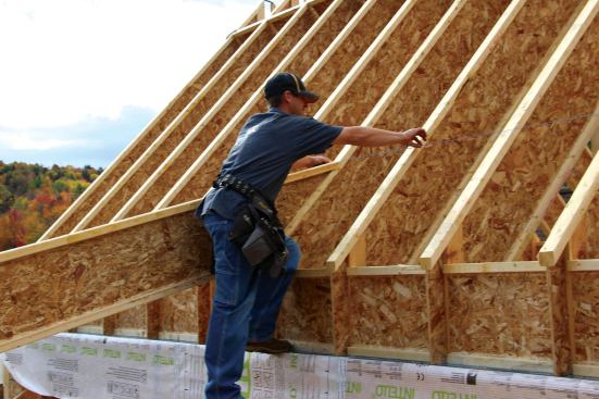 A layout line was snapped between the two rafters to guide placement of the rest.