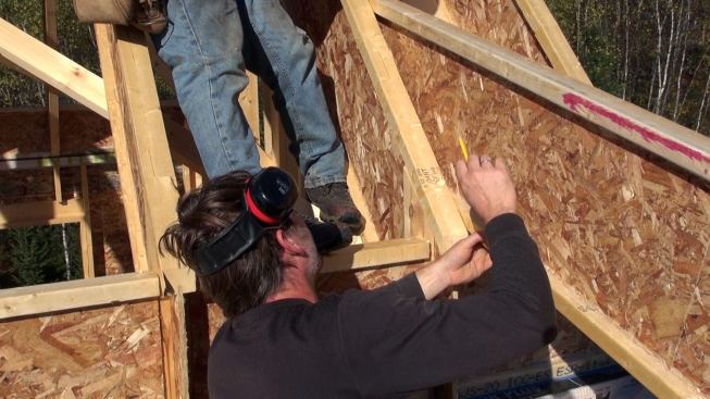 The rafter was held in place to scribe for the cut where the lower rafter would intersect the main roof.